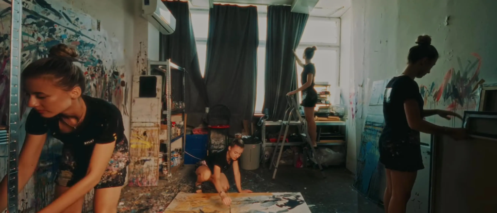 Silvi The Artist working in her studio, captured in multiple moments of her creative process surrounded by abstract paintings.
